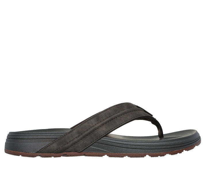 Side view of a gray thong sandal with brown soles.