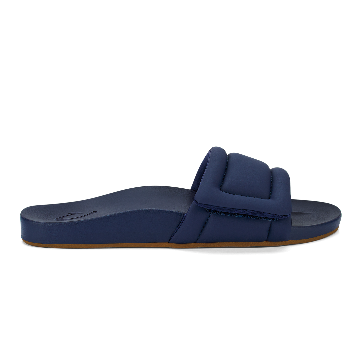 A side view of a navy blue slip-on sandal with a thick, padded strap across the top and a brown sole.