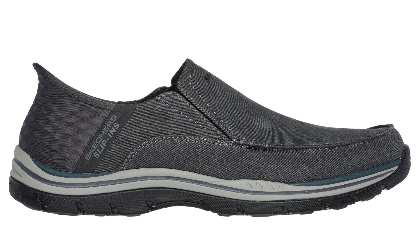 A gray slip-on shoe with a pull tab.