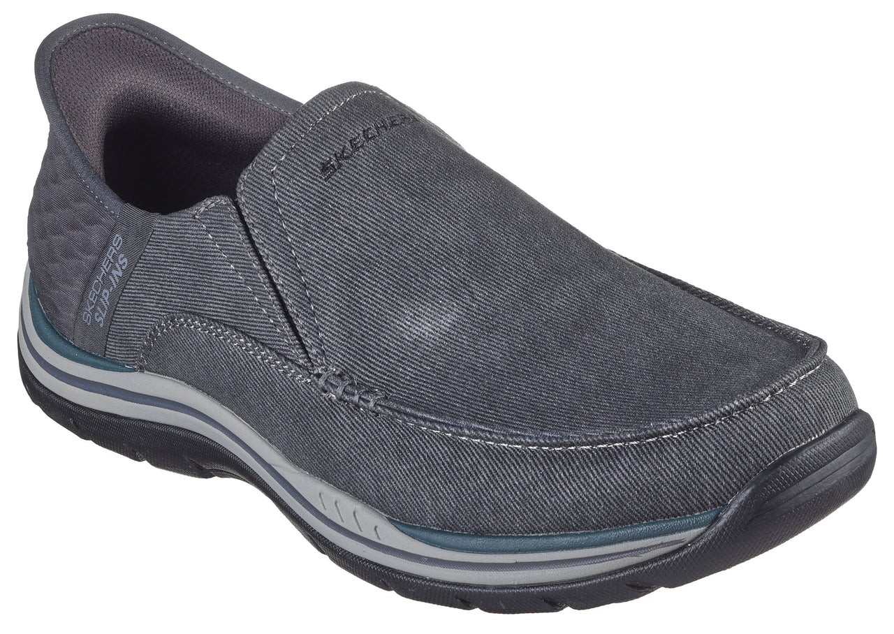 Slip-on gray casual shoe with 'SKECHERS' stitched near the top, decorative stitching near the sole, and a padded heel.