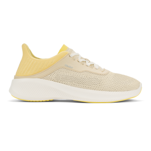 A beige knit sneaker with a white chunky midsole and a pale yellow cushioned heel collar.