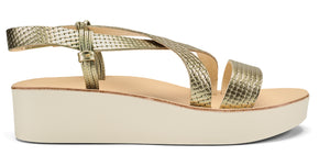 Gold sandal with criss-cross straps and a platform sole.