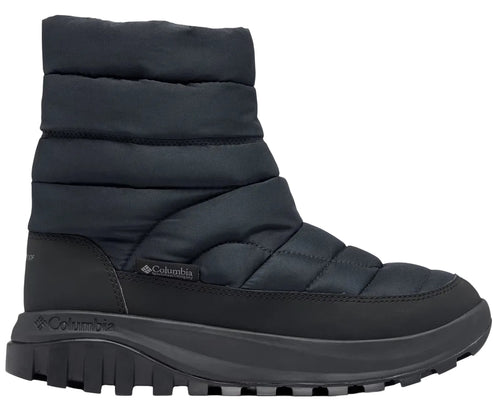 A black Columbia ankle-height quilted winter boot with a thick, textured black rubber sole and a small Columbia logo on the side.