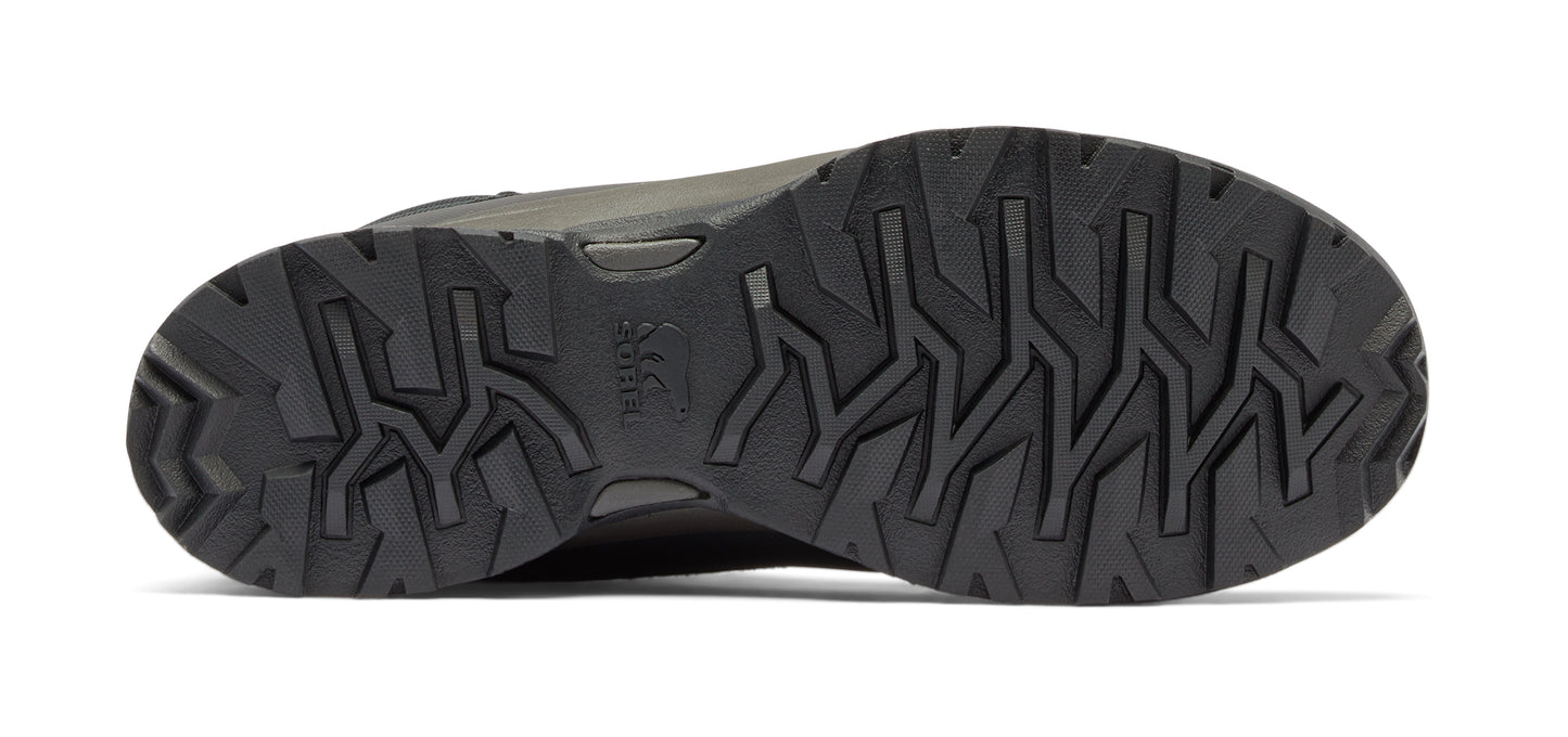Close-up of the sole of a dark colored shoe featuring a geometric tread pattern.