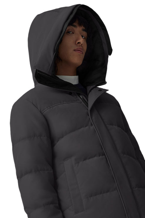 A person wearing a dark gray hooded puffer jacket.