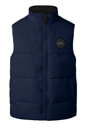 Navy puffer vest with black button closures and a circular logo on the right chest.