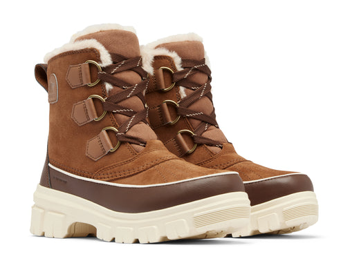 Pair of brown and cream colored suede boots with faux fur trim and lace-up closure.