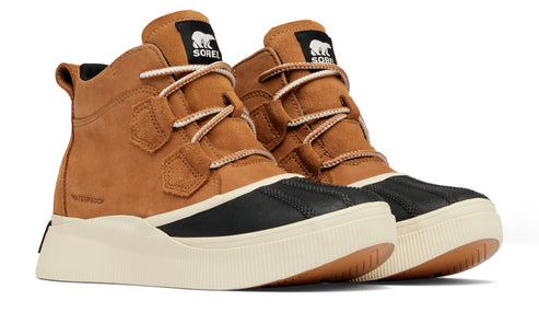 Pair of tan, ankle-high boots with black waterproof toe caps and light beige soles. The tongue has a label with the word SOREL and an image of a bear.