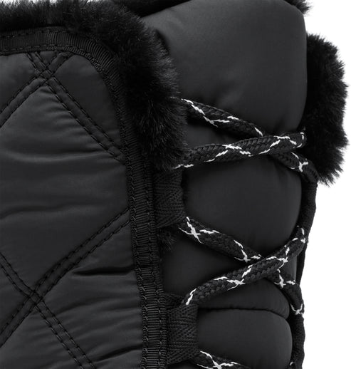 Close-up of black quilted boot with faux fur trim and black and white laces.