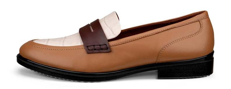 A brown and white leather loafer with a dark brown strap.