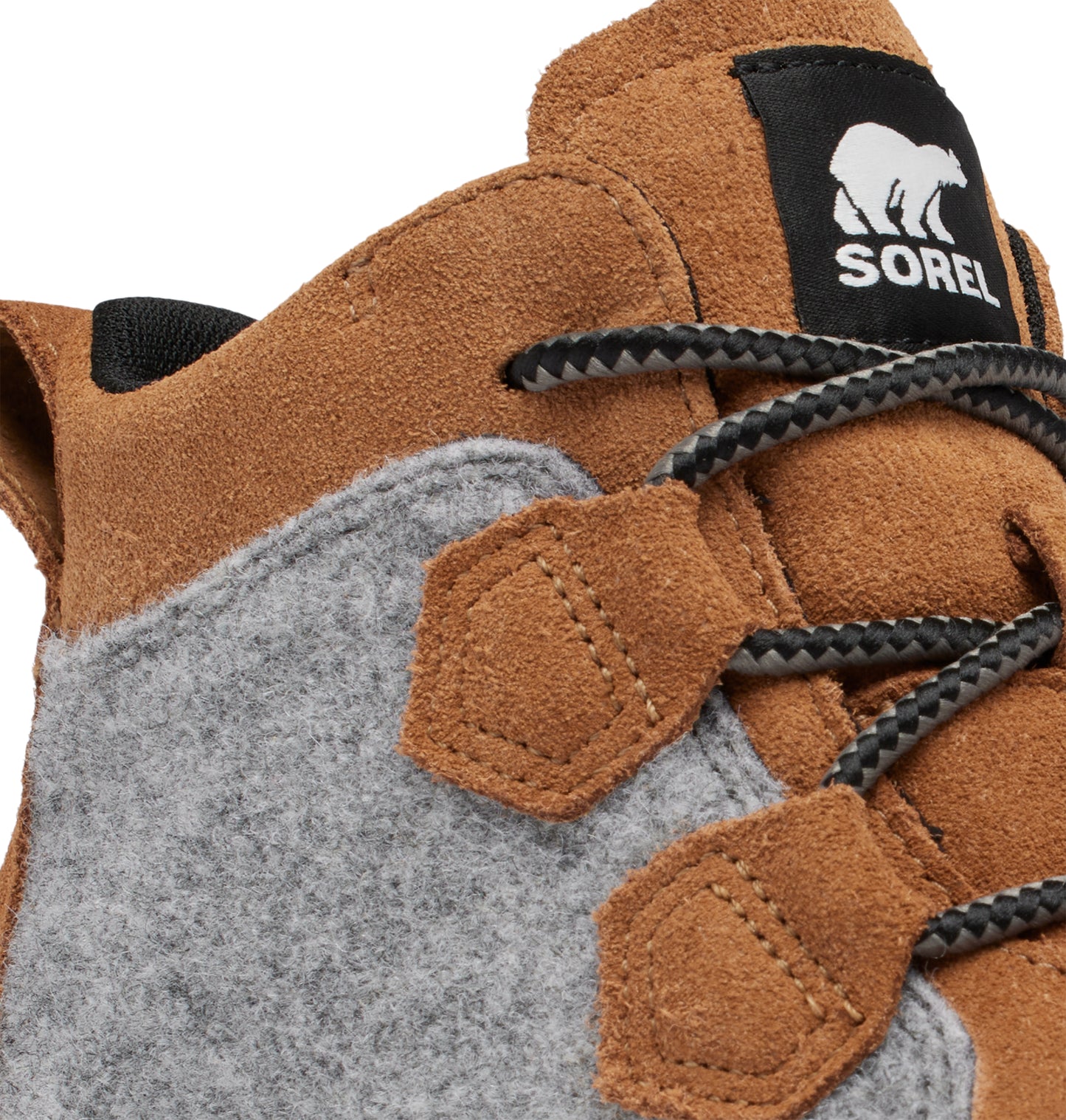 Close-up of a tan boot with grey felt accents and black laces.