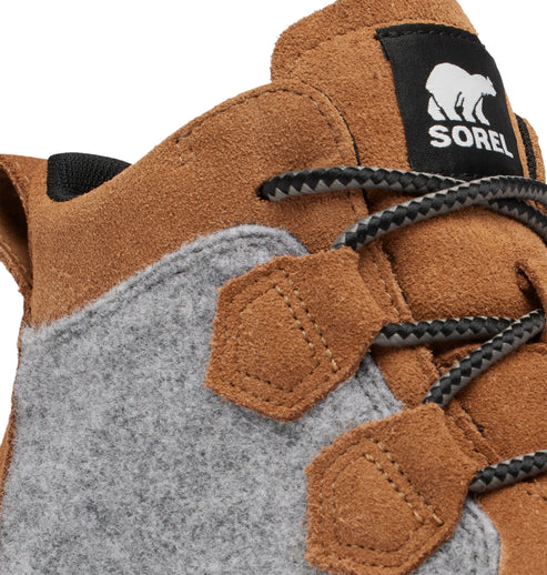 Close-up of a tan boot with grey felt accents and black laces.