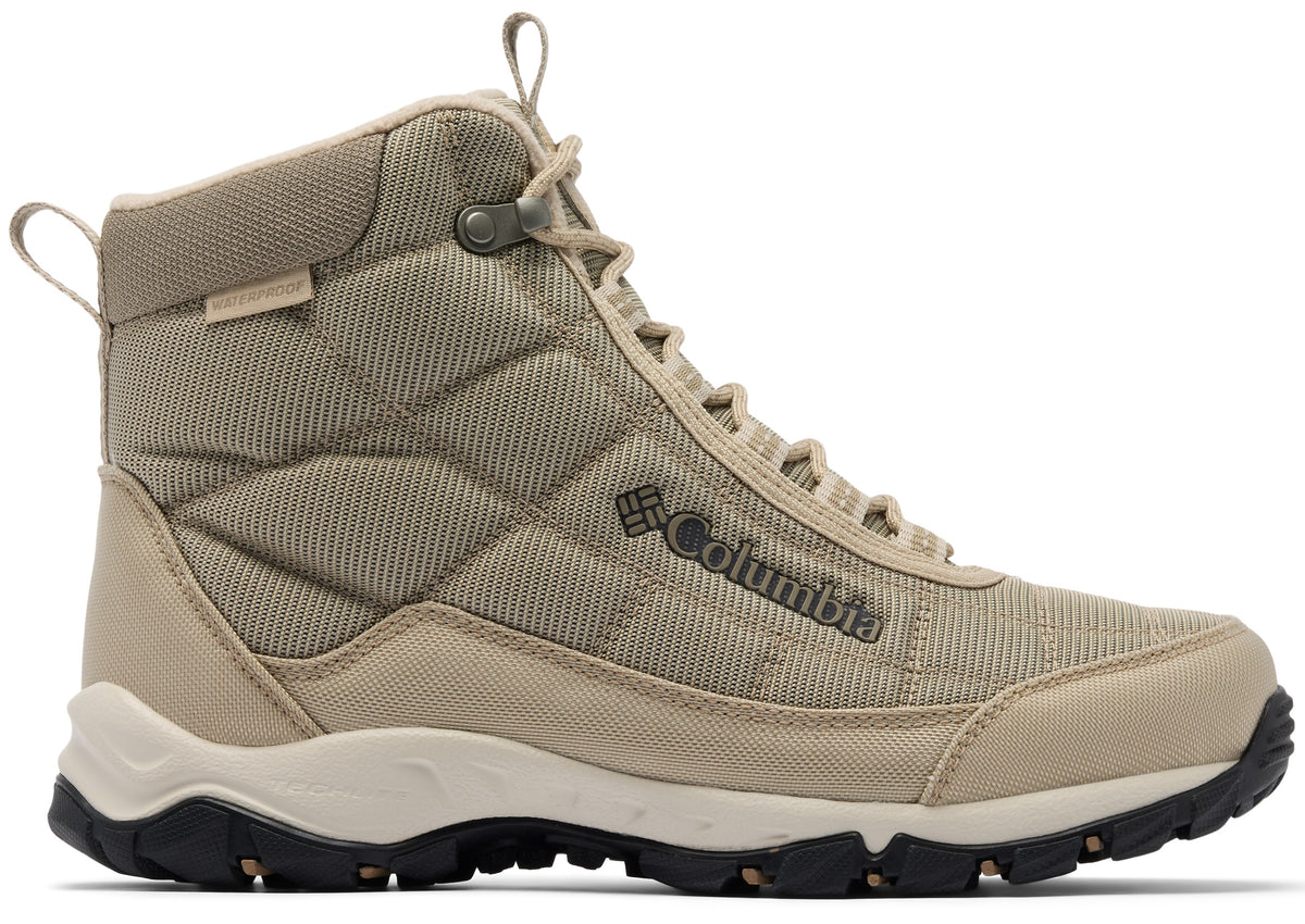 A tan Columbia waterproof high-top hiking boot with a quilted side pattern, lace-up front, a white midsole, and a black, lugged rubber outsole.