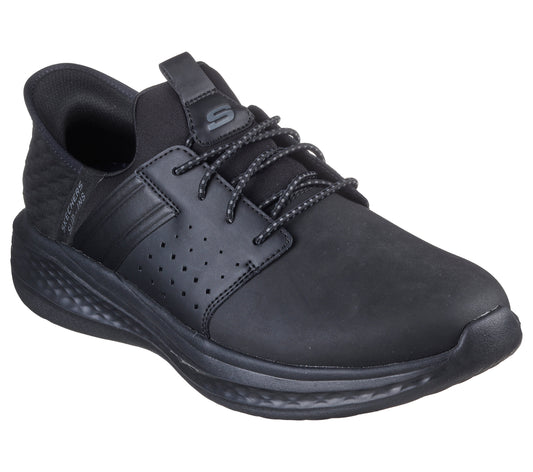 A matte black sneaker with laces, small ventilation holes, and a textured heel.