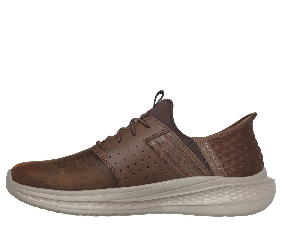 A brown casual shoe with a lace-up closure and a textured sole.