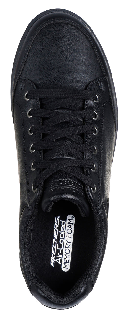 A top-down view of a black shoe with black laces.