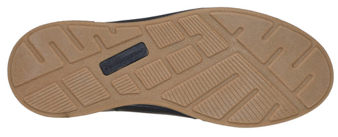 Sole of a shoe with a light brown textured pattern and a dark blue rectangular label.