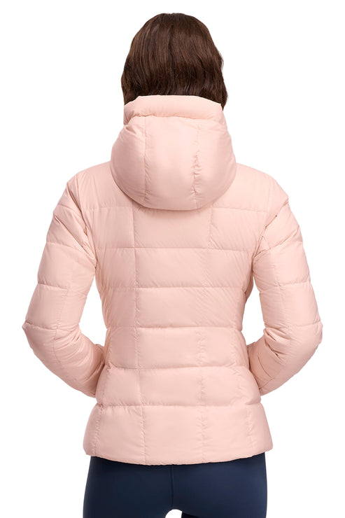 Back view of person wearing a light pink quilted puffer jacket with hood.