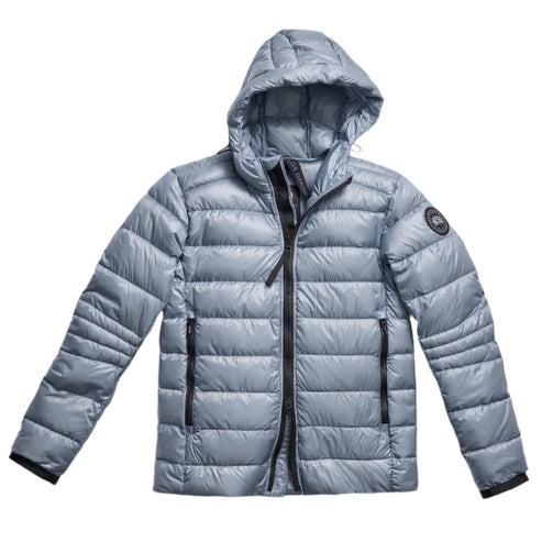 Light blue puffer jacket with hood, zippered front, and zippered pockets.