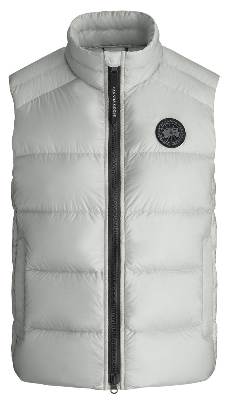 A white puffer vest with a black zipper and a circular logo on the right chest.