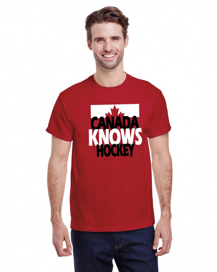 A man wears a red t-shirt with a graphic design of a maple leaf above the text "CANADA KNOWS HOCKEY".