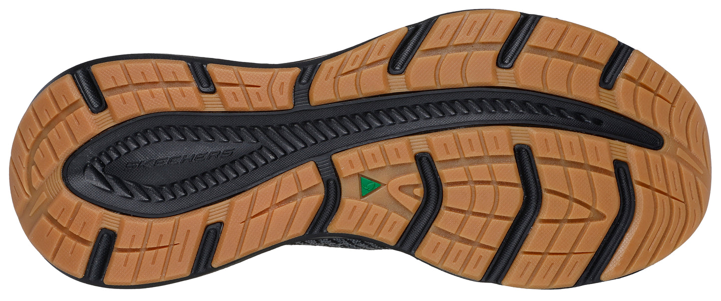 The underside of a shoe with a dark gray base and a light brown treaded sole.