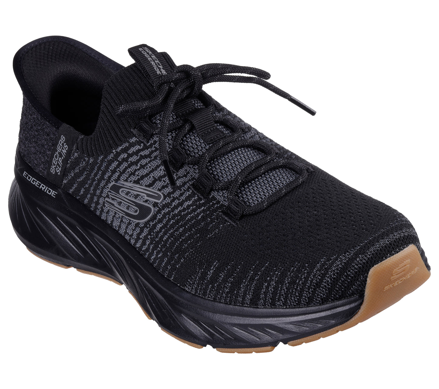 Black sneaker with textured upper, black laces, thick black sole, and tan heel.