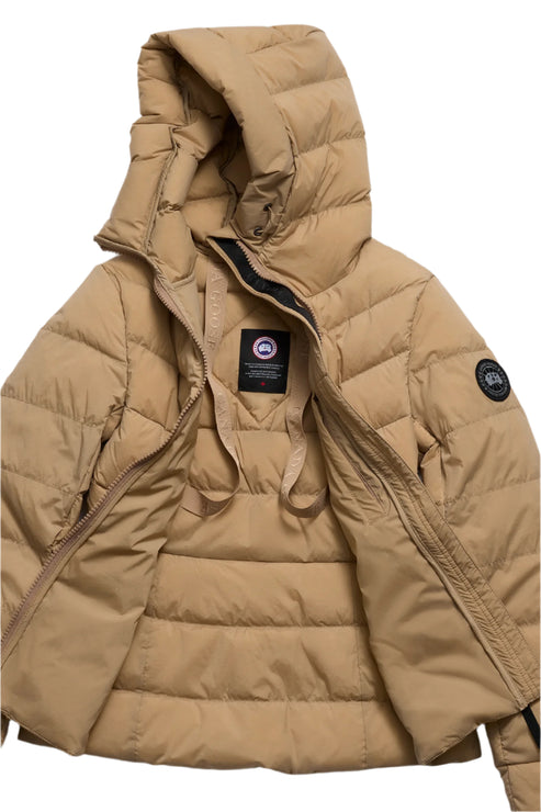 Open, tan puffer jacket with hood and a circular patch logo on the sleeve.