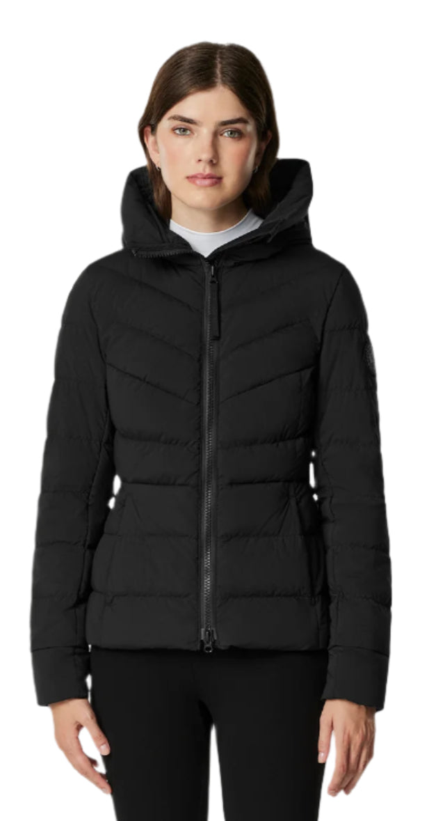 A woman wears a black puffer jacket with a hood and zipper.
