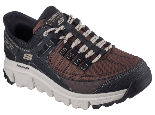 A brown and black athletic shoe with white laces and a white midsole.