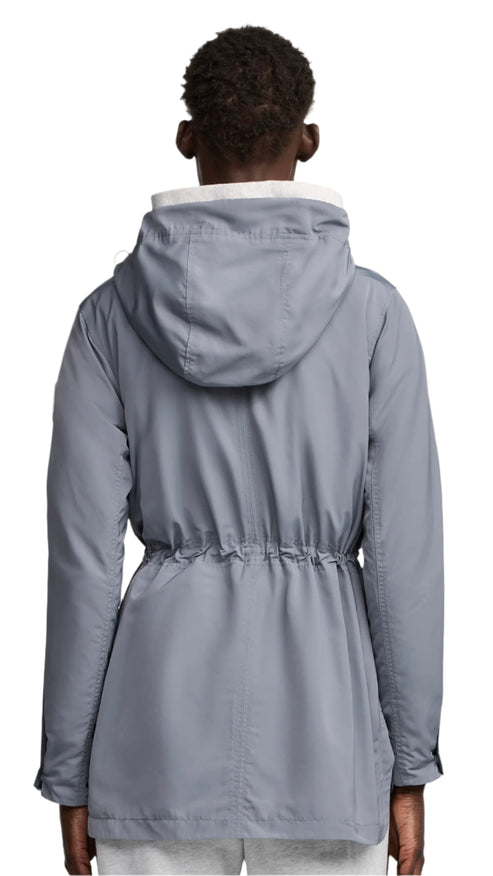 Back view of a person wearing a light gray parka with a hood and a drawstring waist.