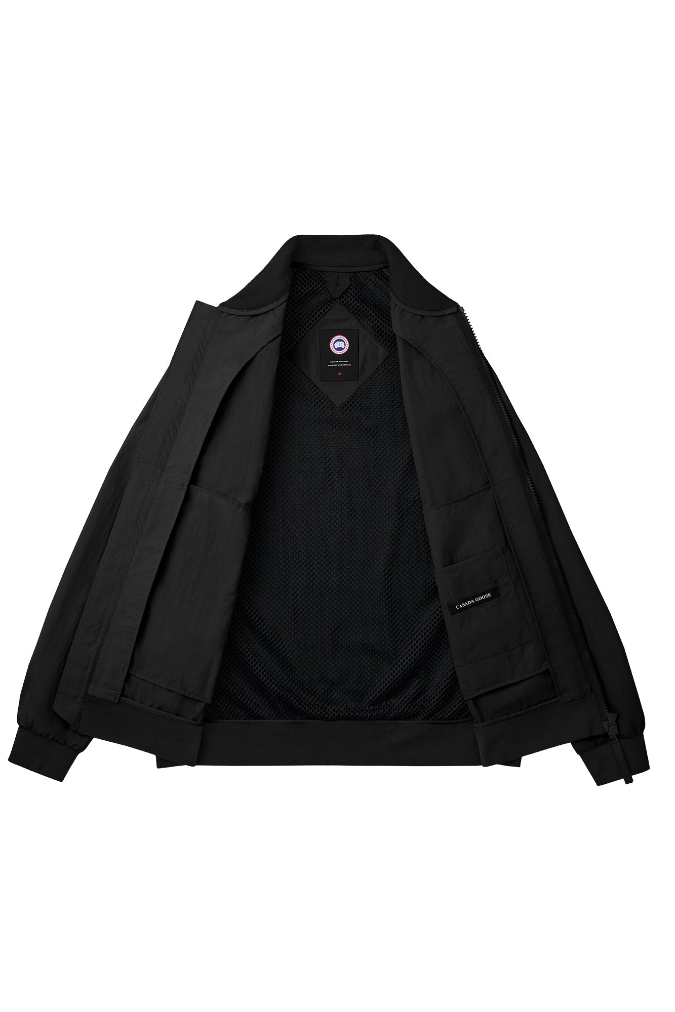 Opened black jacket with label visible near the neck and inside left panel.