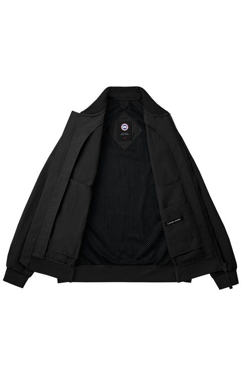 Opened black jacket with label visible near the neck and inside left panel.