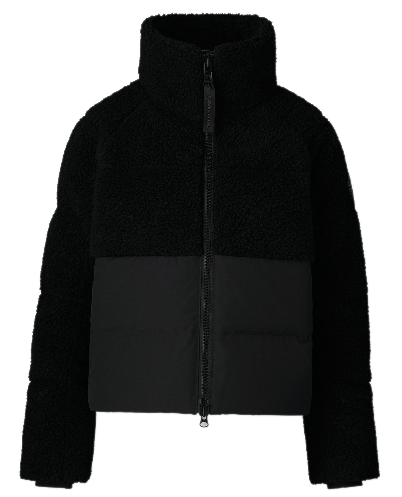 Black jacket with fleece upper and fabric lower, long sleeves, and zippered front.