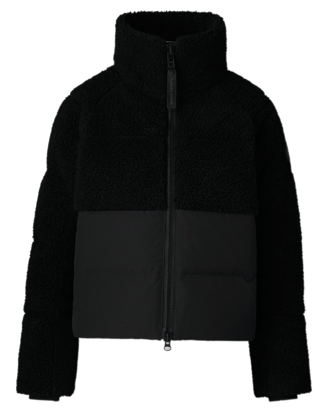 Black jacket with fleece upper and fabric lower, long sleeves, and zippered front.