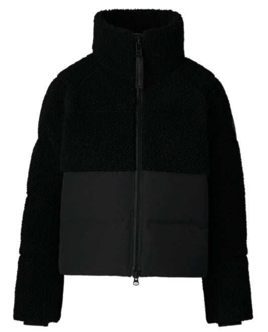 Black jacket with fleece upper and fabric lower, long sleeves, and zippered front.