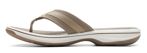 A women's flip-flop with tan straps and a white and tan sole.