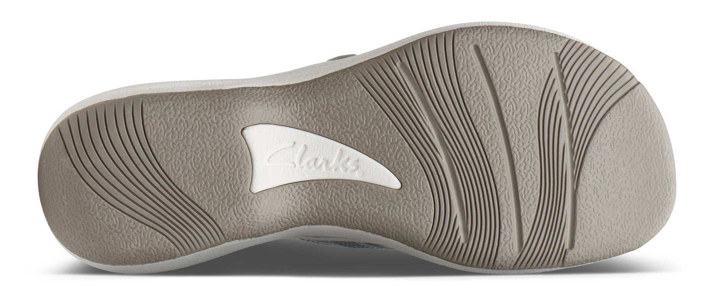 The sole of a shoe features an off-white rubber design with linear grooves and a 'Clarks' logo near the middle.