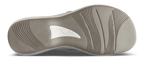 The sole of a shoe features an off-white rubber design with linear grooves and a 'Clarks' logo near the middle.