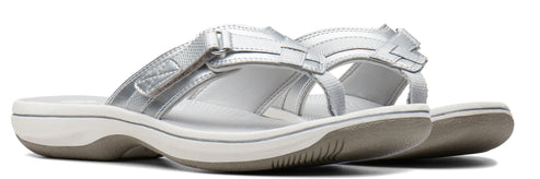 A pair of silver slide sandals with an adjustable strap.