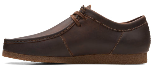 A brown leather casual shoe with laces and a flat sole.