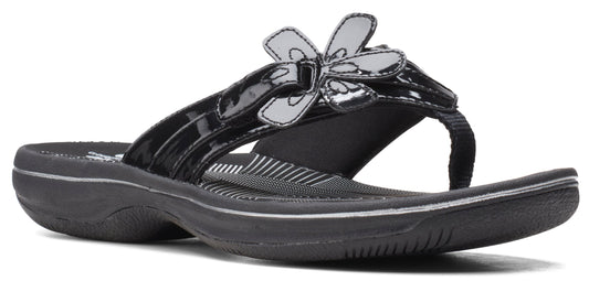 A black sandal with a flower accent on the top.