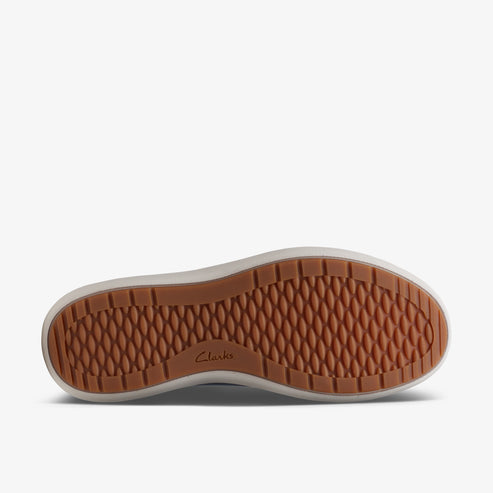The sole of a shoe with hexagon patterned brown rubber and "Clarks" embossed.