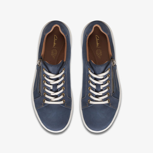 Top-down view of navy blue lace-up sneakers with zippers on either side