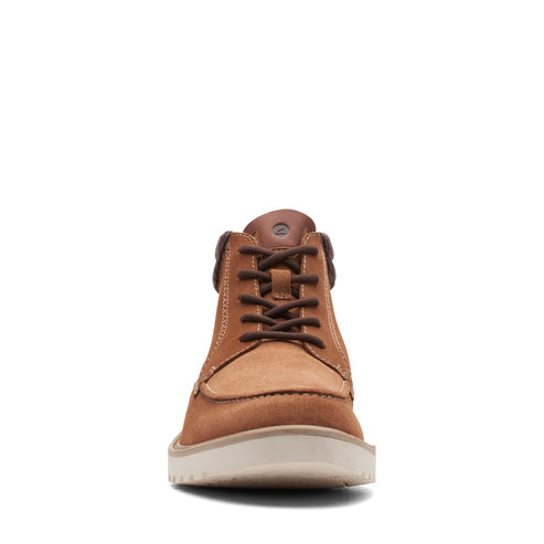 A tan nubuck leather high-top shoe with brown laces and a white sole.