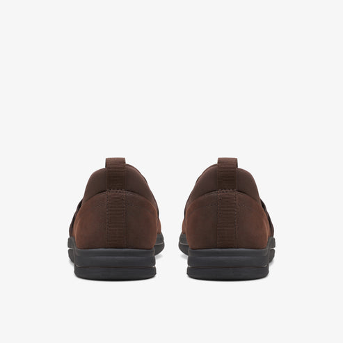 Back view of two brown slip-on shoes with black soles.