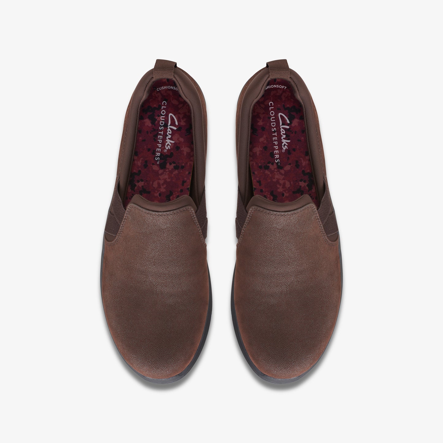 Top-down view of brown slip-on shoes with CLOUDSTEPPERS printed on the inner sole.