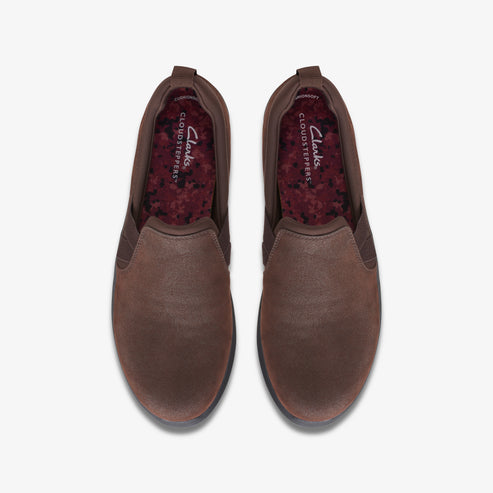 Top-down view of brown slip-on shoes with CLOUDSTEPPERS printed on the inner sole.