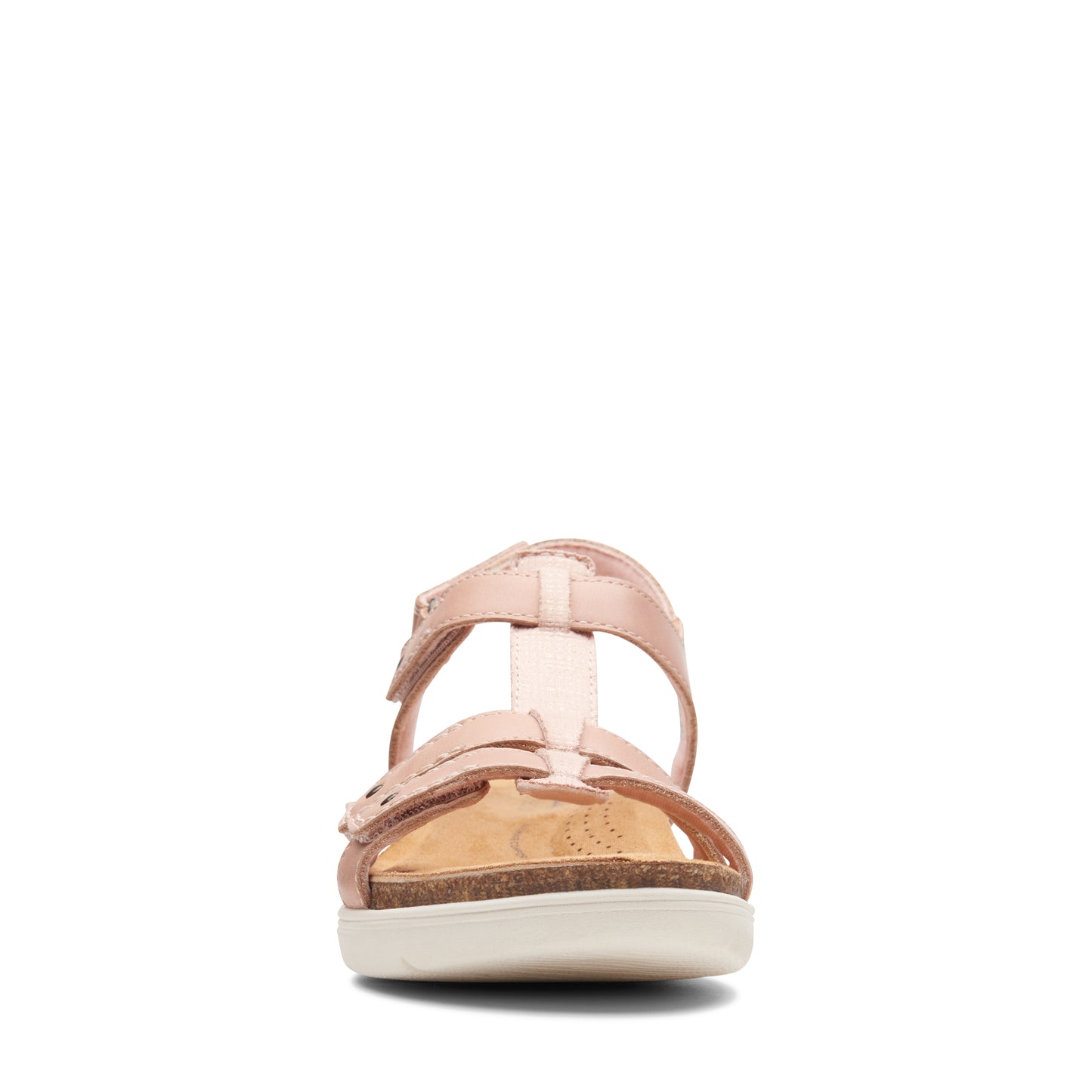 Frontal view of pink T-strap sandals on a white sole.