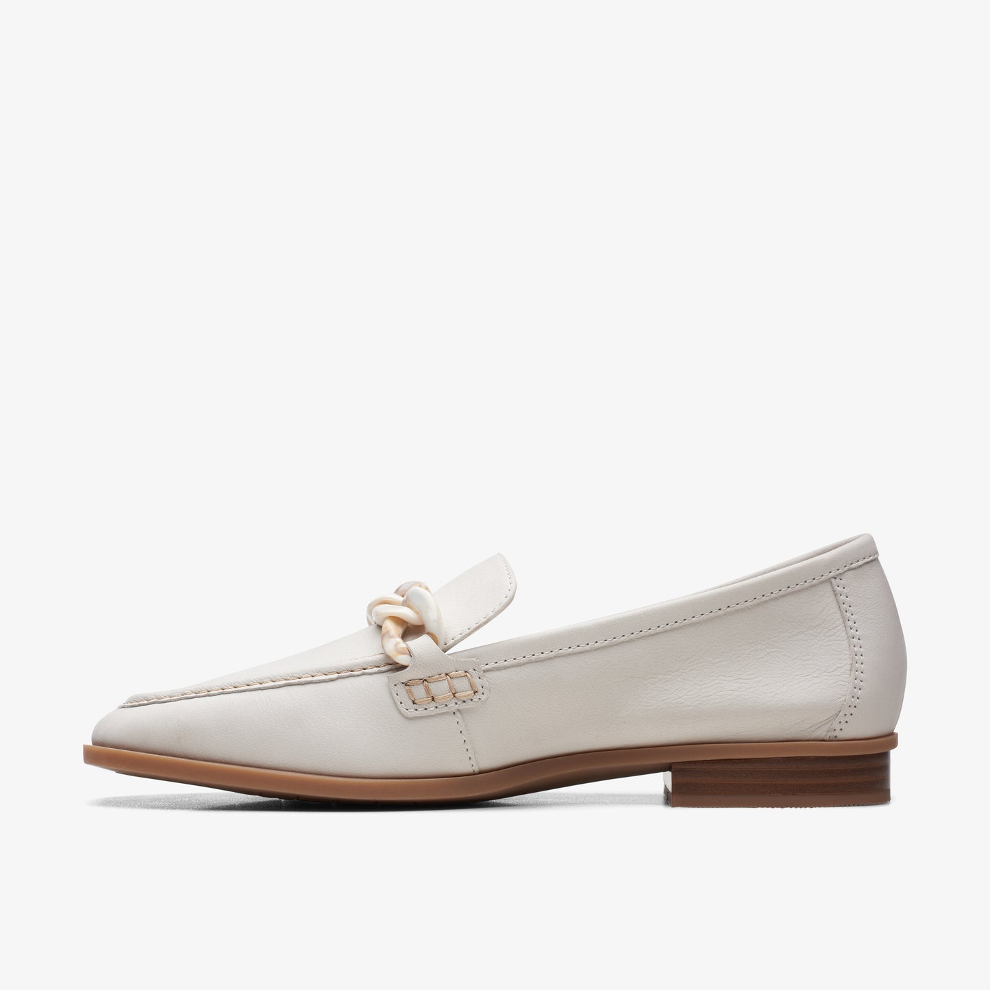 White leather loafer with a square toe and decorative chain on the upper.